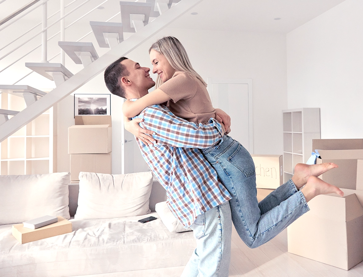 First-time homebuyer couple enjoy dream home.